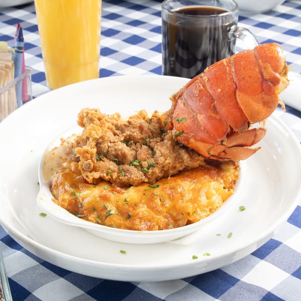 The Breakfast Boys' lobster and fried chicken over mac and cheese, with orange juice and coffee.